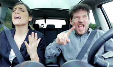 business-man-and-woman-singing-like-crazy-driving-car